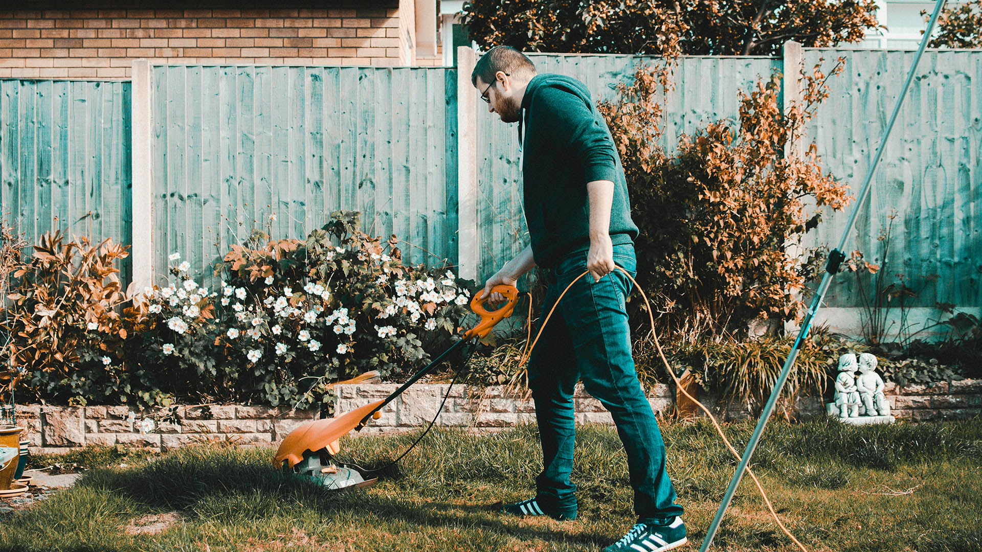 Man doing yard work, maintaining a tidy outdoor space